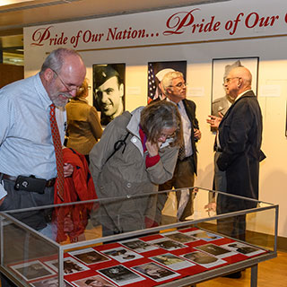 Visitors looking at exhibit in library atrium